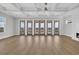 Open-concept living area featuring hardwood floors, coffered ceilings, and access to a balcony with lovely views at 373 St. Julian Ln., Myrtle Beach, SC 29579