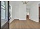 Bright and airy living room with wood-look flooring and white walls, adjacent to the kitchen, awaits your personal touch at 373 St. Julian Ln., Myrtle Beach, SC 29579