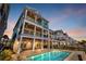 Resort-style backyard with an in-ground pool, covered patios, and an outdoor living space for relaxation and entertainment at 373 St. Julian Ln., Myrtle Beach, SC 29579