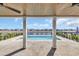 A stunning pool with breathtaking water views from under a covered patio with wood ceilings and white columns at 373 St. Julian Ln., Myrtle Beach, SC 29579