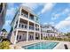 Resort-style backyard with an in-ground pool, covered patios, and outdoor living space for relaxation and entertaining at 373 St. Julian Ln., Myrtle Beach, SC 29579