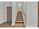 Staircase with illuminated steps and wood handrail in this bright, modern home at 373 St. Julian Ln., Myrtle Beach, SC 29579