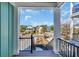 Enjoy neighborhood views from the elevated deck through black railings and support columns at 373 St. Julian Ln., Myrtle Beach, SC 29579