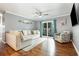 Inviting living room with neutral walls, stylish furnishings, and a sliding glass door to balcony at 3792 Hitchcock Way # 213, Myrtle Beach, SC 29577