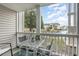 Outdoor patio featuring outdoor furniture with views of a lake and nearby apartment buildings at 3792 Hitchcock Way # 213, Myrtle Beach, SC 29577