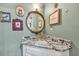 Charming bathroom with ornate mirror, marble countertop, and unique wall decor at 4405 Boxwood St., Myrtle Beach, SC 29577