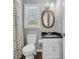 Traditional bathroom with a patterned shower curtain, framed mirror, and neutral walls at 4405 Boxwood St., Myrtle Beach, SC 29577