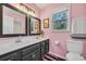 Lovely bathroom with a double sink vanity, framed mirrors, and a pink wall at 4405 Boxwood St., Myrtle Beach, SC 29577