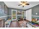 Cozy bedroom featuring gray walls, a ceiling fan, and a desk near the bright windows at 4405 Boxwood St., Myrtle Beach, SC 29577