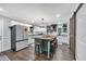 Spacious kitchen featuring an island, stools, white cabinets, and stainless steel appliances at 4405 Boxwood St., Myrtle Beach, SC 29577