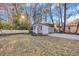 Functional shed with white picket fence and driveway, offering versatile outdoor storage or workshop space at 4405 Boxwood St., Myrtle Beach, SC 29577