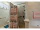 Comfortable shower features a shower curtain, and a toilet is in the background at 4746 Harvest Dr., Myrtle Beach, SC 29579