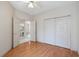 Well-lit bedroom with hardwood floors, closet space, and adjoining doorway at 4746 Harvest Dr., Myrtle Beach, SC 29579