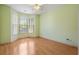 Bright bedroom features large windows, wood flooring, neutral walls, and a ceiling fan at 4746 Harvest Dr., Myrtle Beach, SC 29579