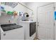 Well-organized laundry room features a washer and dryer, utility sink and ample storage at 4746 Harvest Dr., Myrtle Beach, SC 29579