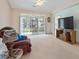 Spacious living room with sliding glass doors, neutral carpet, and a relaxed atmosphere for entertainment at 4746 Harvest Dr., Myrtle Beach, SC 29579