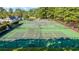 An overhead view of community tennis courts, showcasing a well-maintained green playing surface with black perimeter fencing at 4746 Harvest Dr., Myrtle Beach, SC 29579