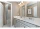 Bathroom featuring double sinks, a large mirror, and a walk-in shower with a blue-patterned curtain at 543 Slaty Dr., Myrtle Beach, SC 29588