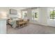 Well-lit bedroom featuring neutral tones, large windows, and a decorative bench at 543 Slaty Dr., Myrtle Beach, SC 29588