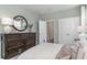 Inviting bedroom with a wooden dresser, a decorative mirror, and plush bedding at 543 Slaty Dr., Myrtle Beach, SC 29588