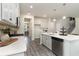 Well-appointed kitchen with white cabinetry, quartz counters, stainless appliances, and gray wood-look floors at 543 Slaty Dr., Myrtle Beach, SC 29588