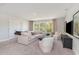 Bright living room featuring a comfortable white sofa, natural lighting, and neutral decor at 543 Slaty Dr., Myrtle Beach, SC 29588