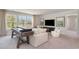 Bright living room featuring a comfortable white sofa, natural lighting, and a shuffleboard game table at 543 Slaty Dr., Myrtle Beach, SC 29588