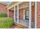 Inviting brick front porch with stately columns and cozy rocking chairs at 5508 Leatherleaf Dr., North Myrtle Beach, SC 29582