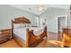 A spacious main bedroom showcases a decorative wood bed frame and beautiful hardwood floors at 5508 Leatherleaf Dr., North Myrtle Beach, SC 29582