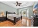 Relaxing main bedroom with a tray ceiling, a ceiling fan, and a large window at 5508 Leatherleaf Dr., North Myrtle Beach, SC 29582