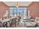 Well-lit sunroom with brick walls, large windows, ceiling fan, and comfortable seating at 5508 Leatherleaf Dr., North Myrtle Beach, SC 29582