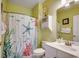 Well-lit bathroom with decorative shower curtain and white vanity at 5750 Oyster Catcher Dr. # 522, North Myrtle Beach, SC 29582