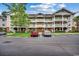 Three story condo complex with brick facade and white staircases, and parking at 5750 Oyster Catcher Dr. # 522, North Myrtle Beach, SC 29582