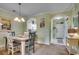 Bright dining area with a rustic table, elegant lighting, and seamless access to the kitchen at 5750 Oyster Catcher Dr. # 522, North Myrtle Beach, SC 29582