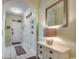 Neutral hallway featuring tiled floors, a decorative mirror, and access to bedrooms at 5750 Oyster Catcher Dr. # 522, North Myrtle Beach, SC 29582