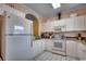 Functional kitchen featuring ample cabinet space, white appliances, and granite countertops at 5750 Oyster Catcher Dr. # 522, North Myrtle Beach, SC 29582