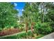 Lush landscaping frames this community's serene walking path and towering palm trees on a bright, sunny day at 5750 Oyster Catcher Dr. # 522, North Myrtle Beach, SC 29582