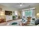 Relaxing living room with a television, a ceiling fan, and a sliding glass door to the balcony at 5750 Oyster Catcher Dr. # 522, North Myrtle Beach, SC 29582