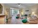 Inviting living room with wicker furniture, a ceiling fan, and sliding glass doors to the balcony at 5750 Oyster Catcher Dr. # 522, North Myrtle Beach, SC 29582