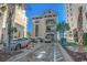 Well maintained parking area in between buildings and palm trees on a sunny day with blue skies at 5750 Oyster Catcher Dr. # 522, North Myrtle Beach, SC 29582