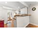 Bright kitchen with wood floors, white cabinets, and a view into another room at 607 18Th Ave. S, North Myrtle Beach, SC 29582