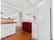 Open kitchen featuring white cabinetry, hardwood floors and stainless steel refrigerator at 607 18Th Ave. S, North Myrtle Beach, SC 29582