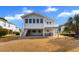 Backyard of elevated home features a ground-level patio, swing and staircase to the upper deck at 609 23Rd Ave. N, North Myrtle Beach, SC 29582