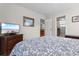 Bedroom featuring floral bedding, a TV, and a view to the kitchen at 609 23Rd Ave. N, North Myrtle Beach, SC 29582