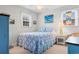 Bedroom features light blue bedding, wicker furniture, natural light, and coastal themed decorations at 609 23Rd Ave. N, North Myrtle Beach, SC 29582