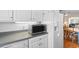 Close up of a white kitchen featuring gray countertops and a white refrigerator and microwave at 609 23Rd Ave. N, North Myrtle Beach, SC 29582