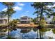 Scenic waterfront home with lush trees reflecting on the calm water at 609 23Rd Ave. N, North Myrtle Beach, SC 29582