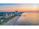 Sunrise aerial showcasing the shoreline, buildings, and the Myrtle Beach SkyWheel at 6804 N Ocean Blvd. # 533, Myrtle Beach, SC 29572