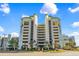 Spacious multi-story building with a parking garage and mature palms at 6804 N Ocean Blvd. # 533, Myrtle Beach, SC 29572