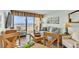 Bright living room with ocean view, wood floors, a couch, a table, and comfy chairs at 6804 N Ocean Blvd. # 533, Myrtle Beach, SC 29572